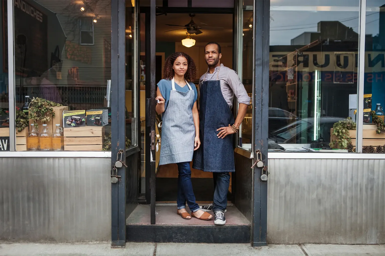 A man and woman stand outside a business